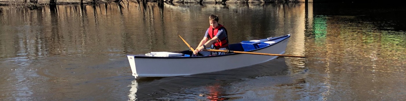 Capt. Skelly at helm of rowboat